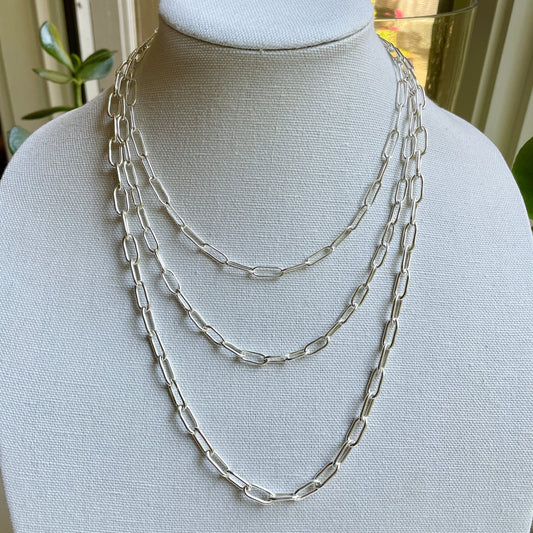 Handmade sterling silver oval link chains stacked and displayed on a bust. Handmade by Will Macy of Accent Yourself.