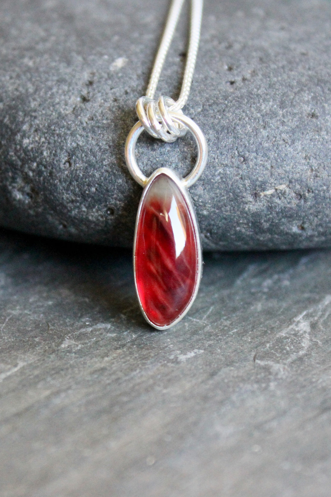 red oregon sunstone set in a fine and sterling silver bezel on a sturdy chain
