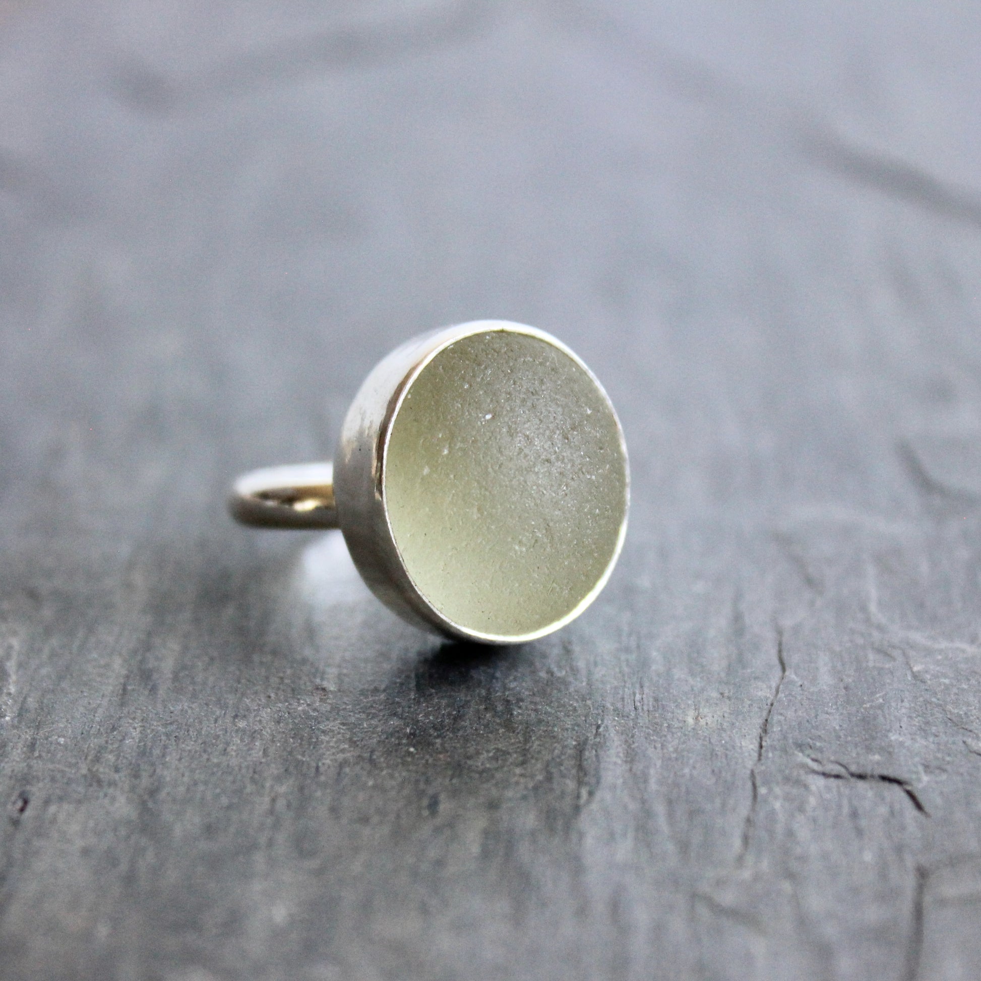 Silver ring on a textured gray surface