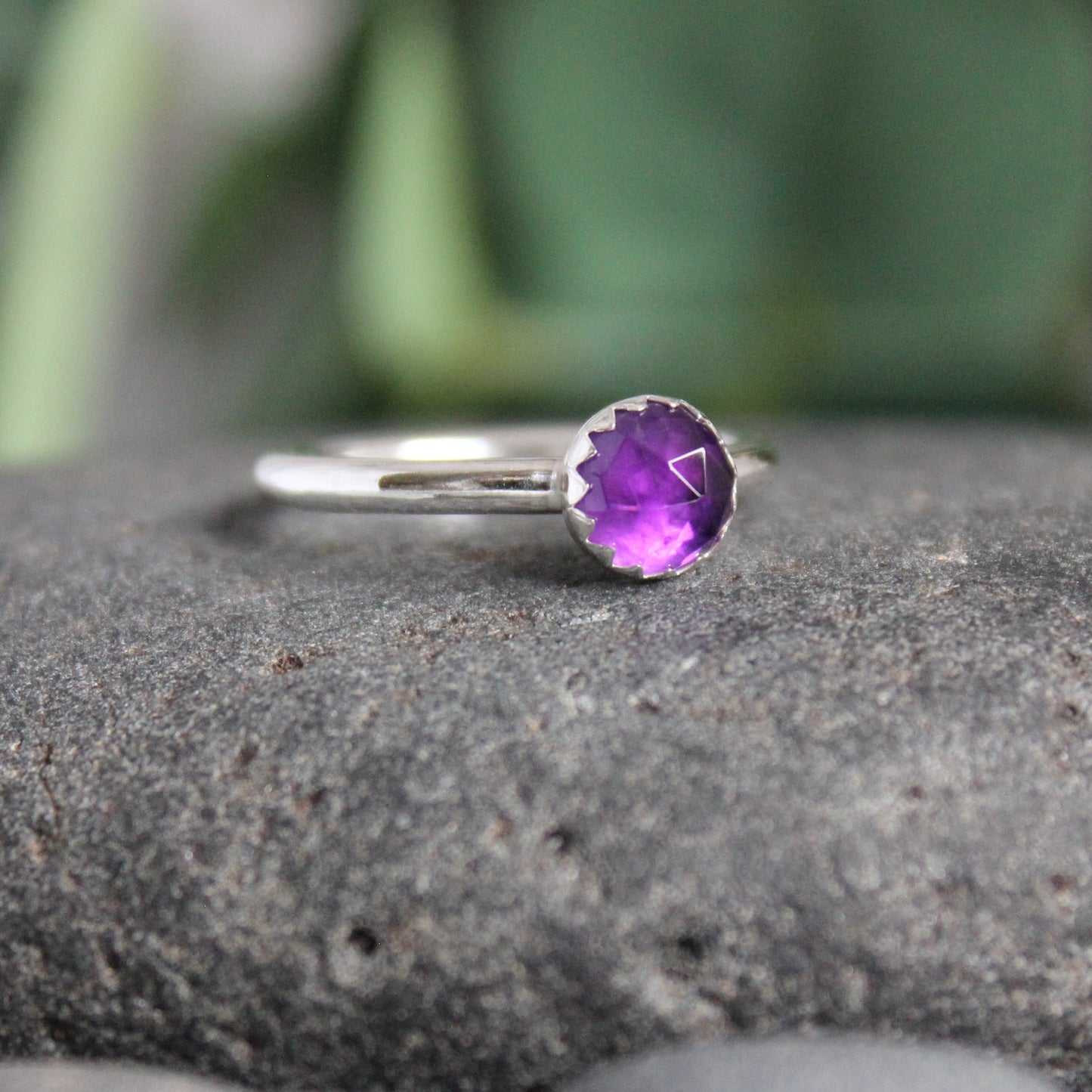 This is a 6mm rose cut round amethyst cabochon set in a sterling silver bezel setting on a sturdy silver band. 