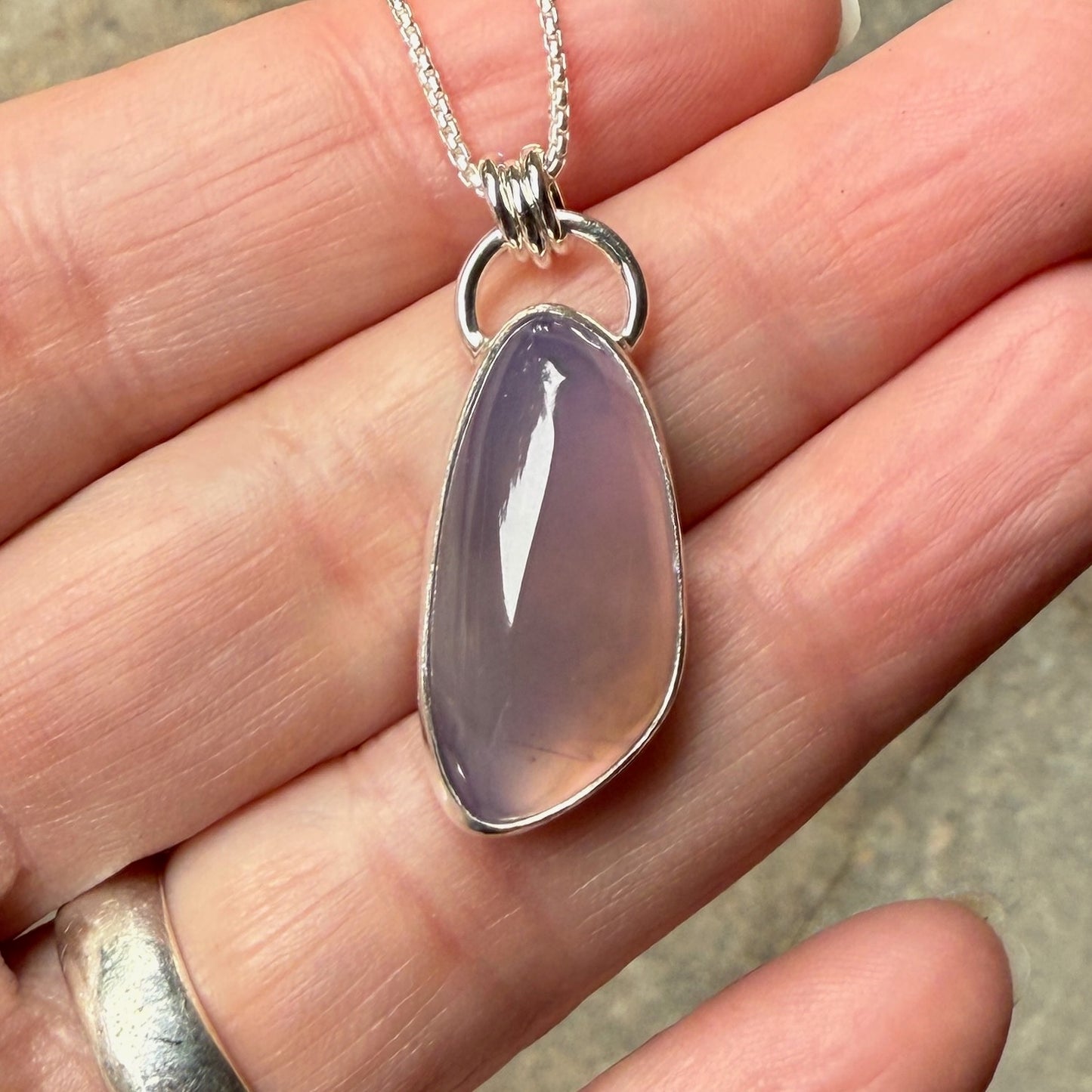 This is a large Oregon holley blue agate cabochon that is set in a fine and sterling silver bezel setting on a sturdy sterling silver chain.  