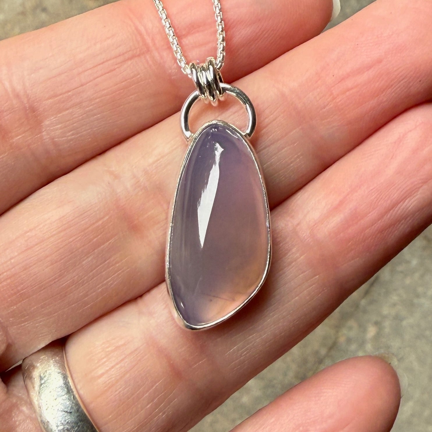 This is a large Oregon holley blue agate cabochon that is set in a fine and sterling silver bezel setting on a sturdy sterling silver chain.  