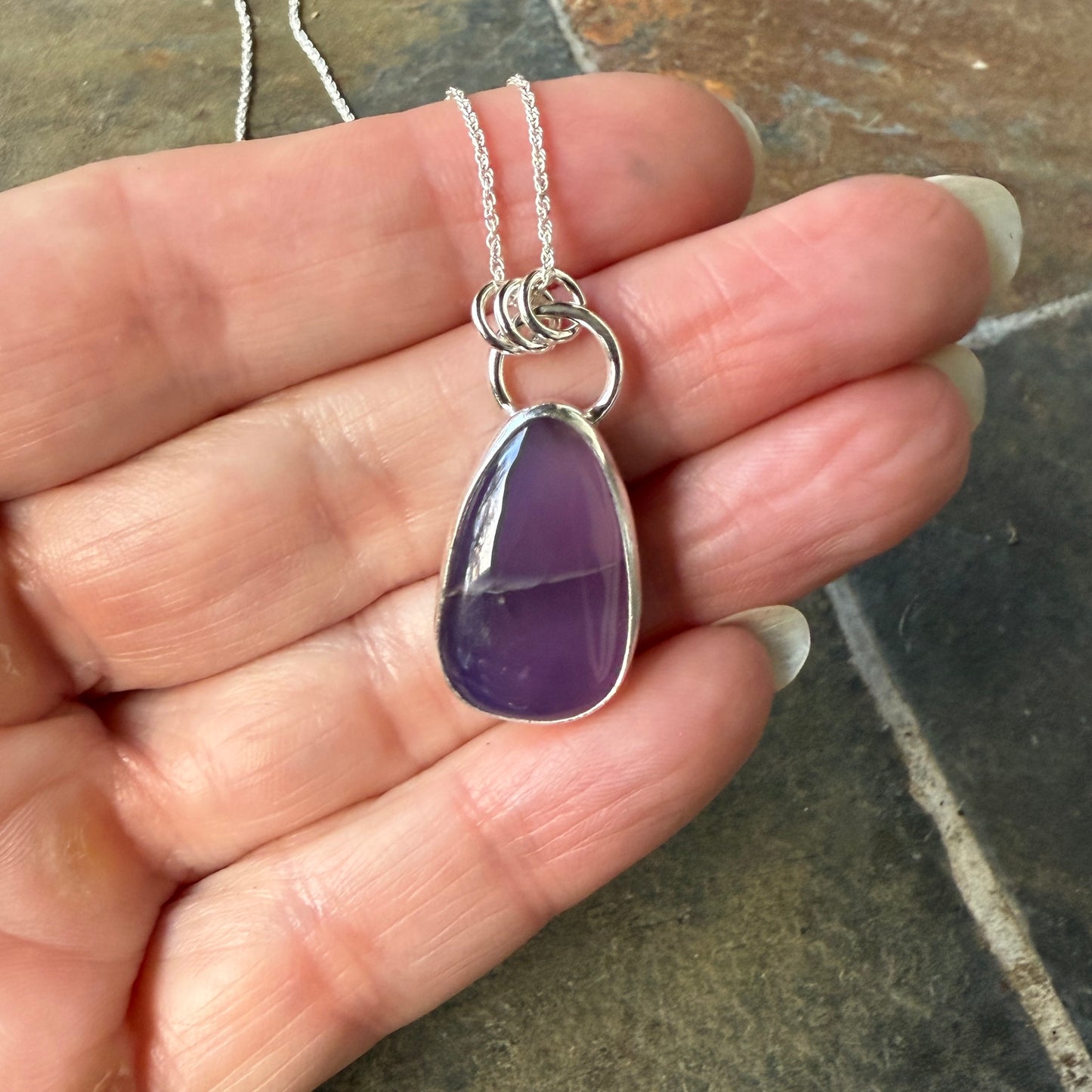 This pendant has a large Oregon Holley Blue agate cabochon that is set in a fine and sterling silver bezel setting and comes with a sterling silver chain.  Handmade by Will Macy in Corvallis, OR.