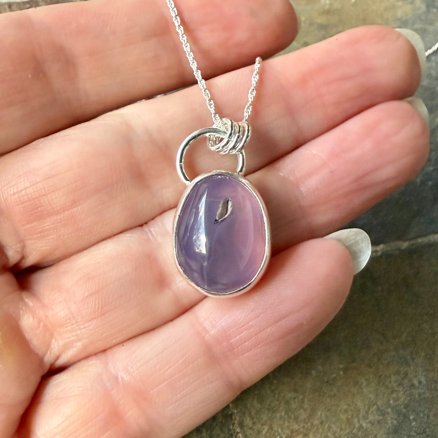 This pendant has a large Oregon Holley Blue agate cabochon that is set in a fine and sterling silver bezel setting and comes with a sterling silver chain.  Handmade by Will Macy in Corvallis, OR.