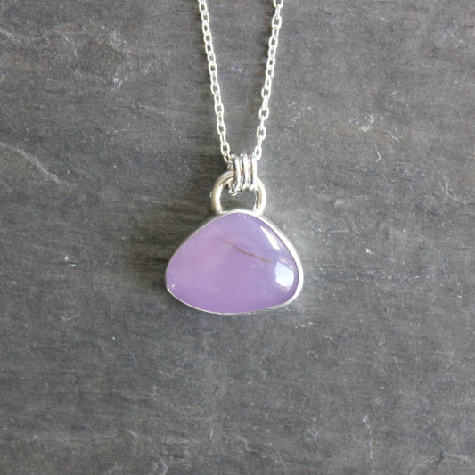 Necklace with a purple holley blue agate pendant on a gray slate background