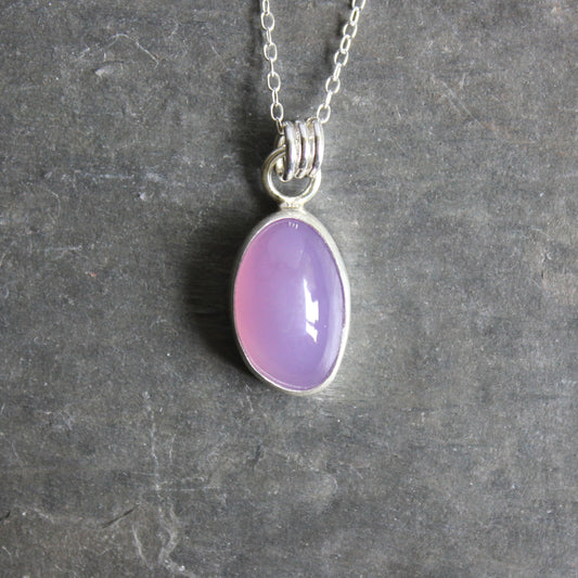 Holley Blue Agate pendant on a silver chain against a gray background