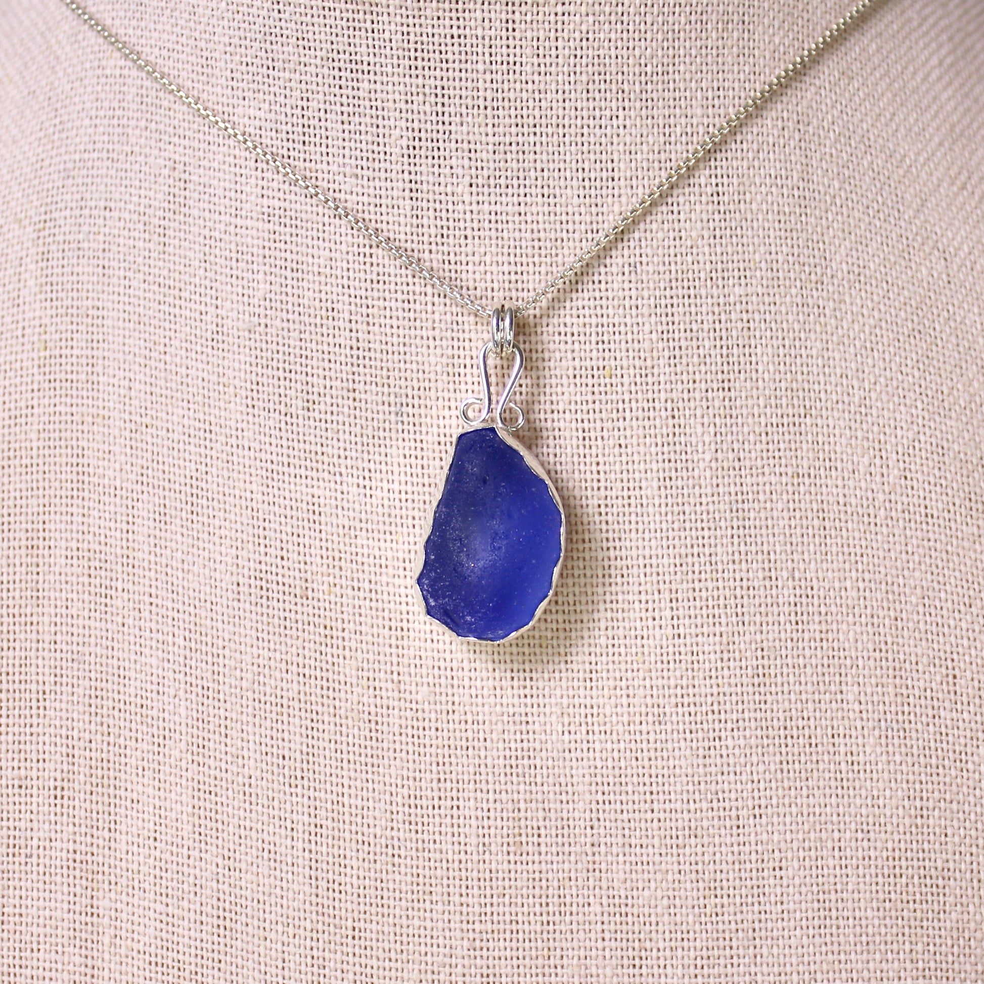 Sterling silver cobalt sea glass set in a fine and sterling silver bezel setting on a sterling silver chain.