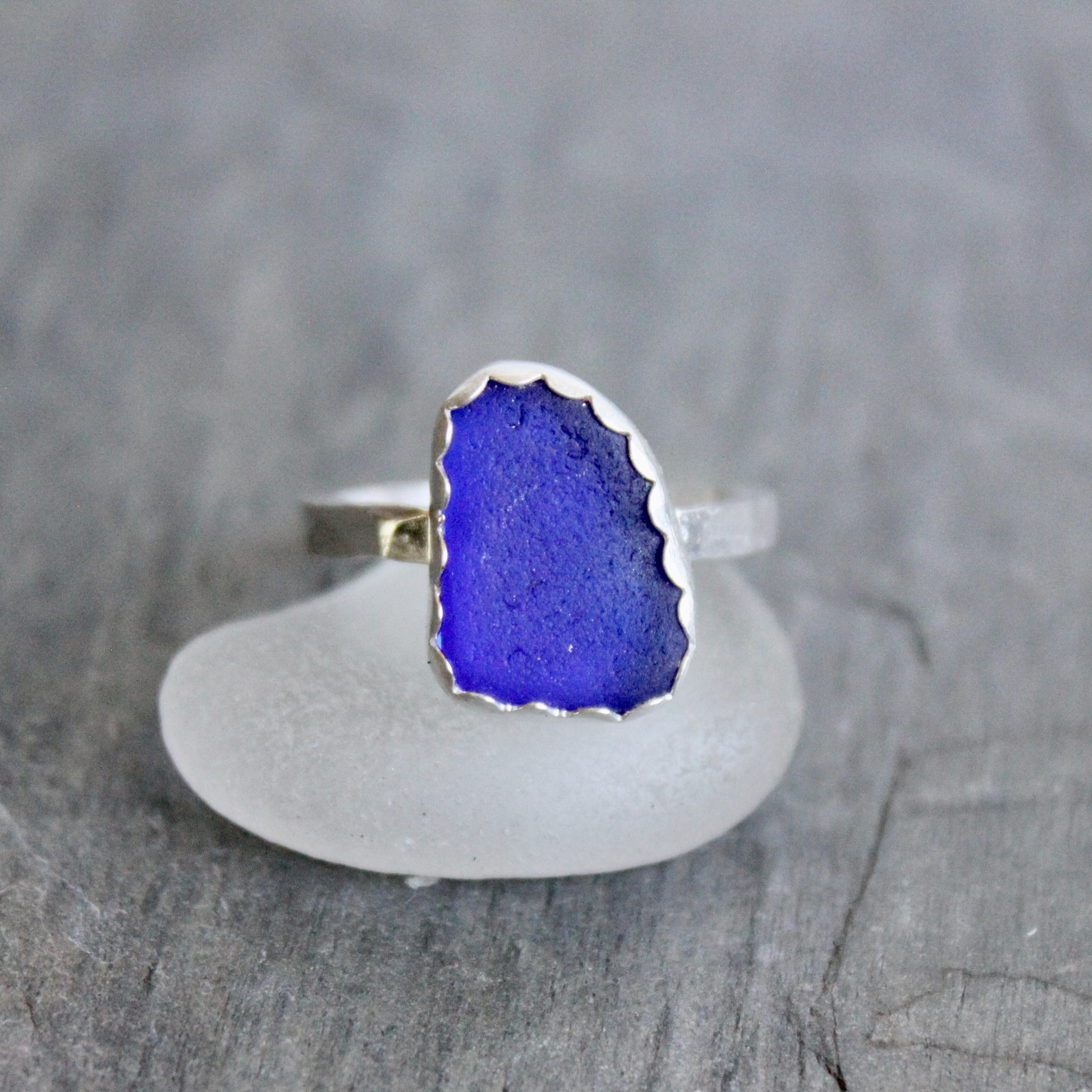 Ring with blue stone on a gray surface