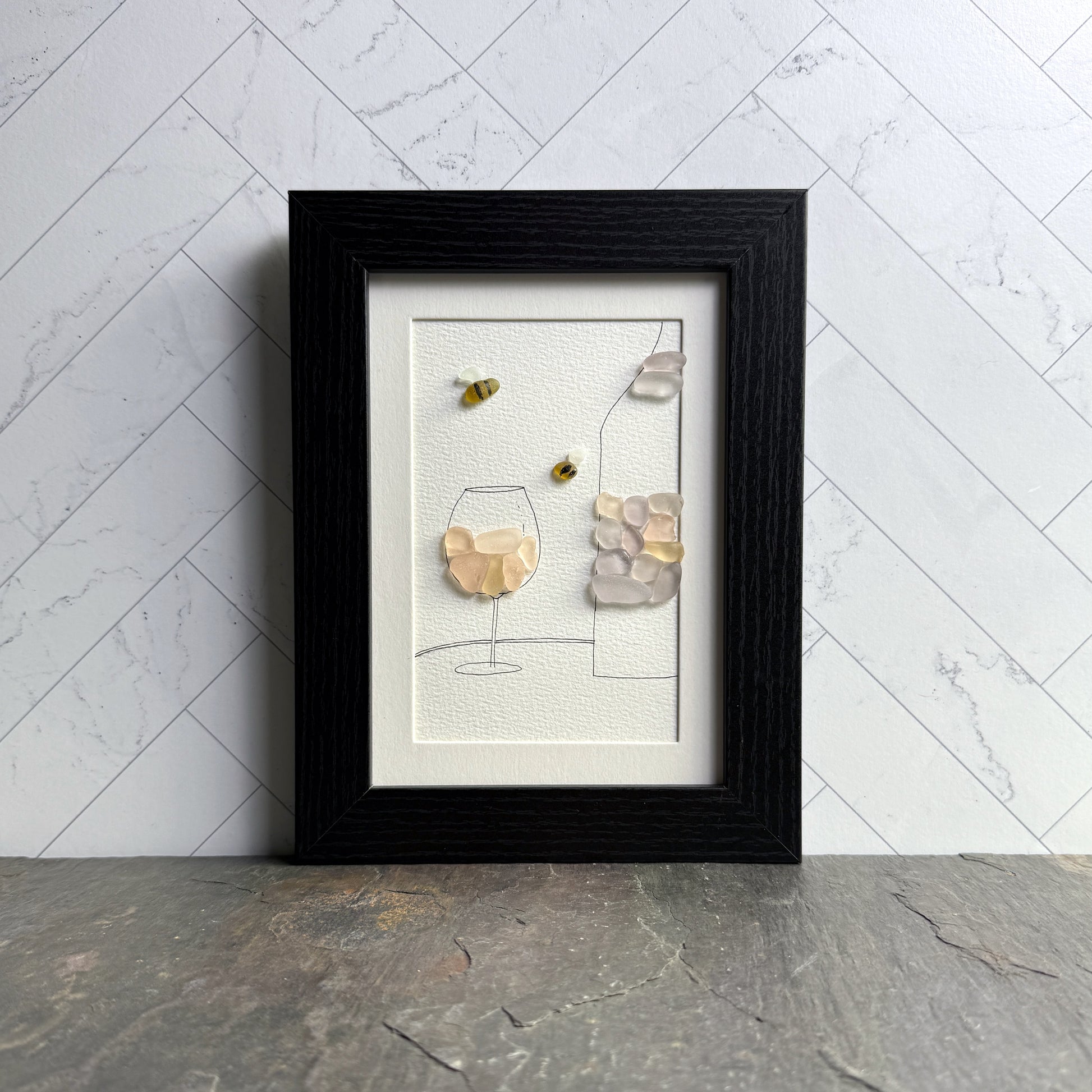 Framed artwork with abstract design on a marble wall background