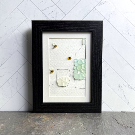 Framed artwork of a glass with geometric shapes on a white background