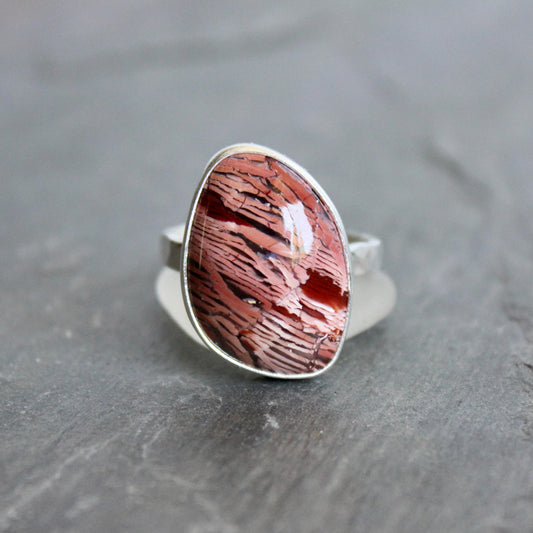This large ring has a freeform rattlesnake jasper or Howardite cabochon that is set in a fine and sterling silver bezel setting on a sturdy hammered band. Size 11 3/4 Handmade by Will Macy in Corvallis, Oregon.