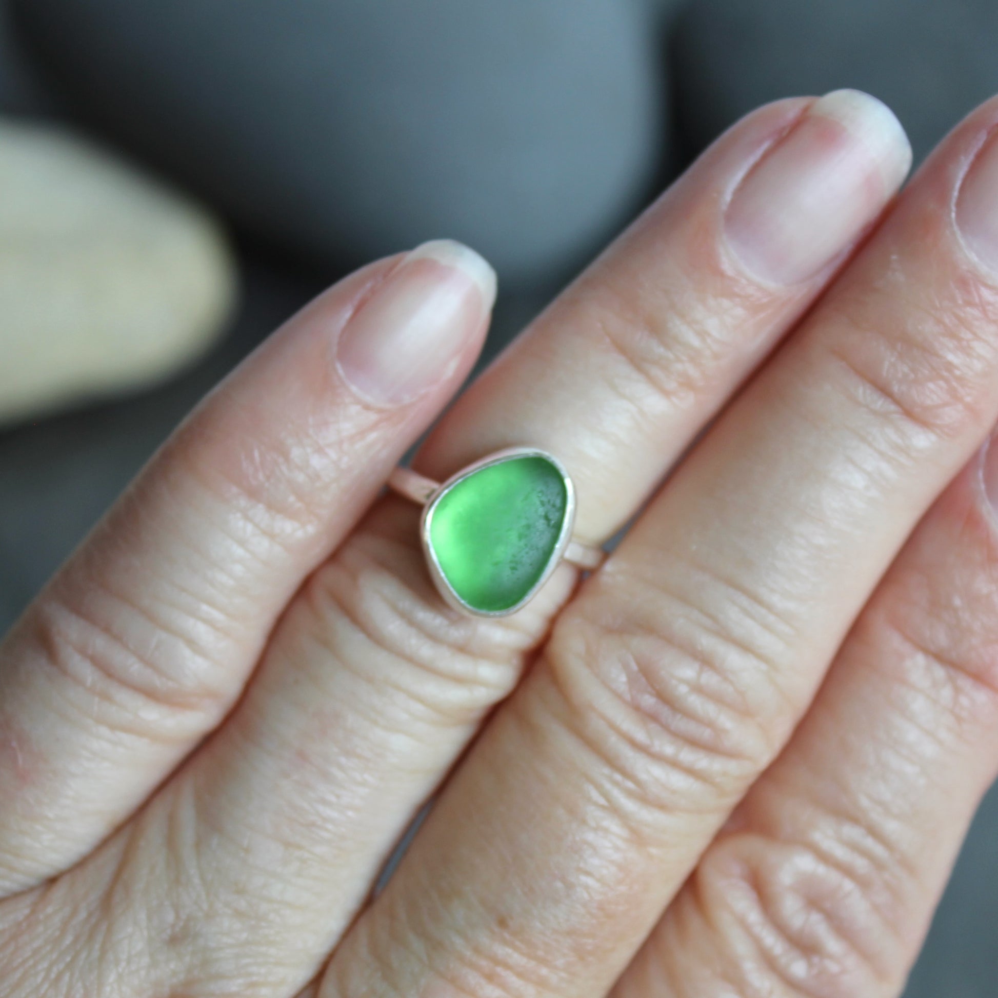 This ring has a small piece of bright green sea glass that is set in a fine and sterling silver bezel setting on a sturdy silver band. Size 5. Handmade by Barb Macy in Corvallis, OR.
