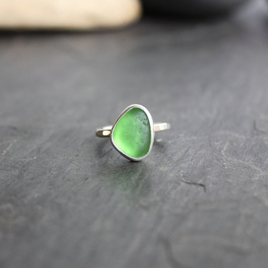 This ring has a small piece of bright green sea glass that is set in a fine and sterling silver bezel setting on a sturdy silver band. Size 5. Handmade by Barb Macy in Corvallis, OR.