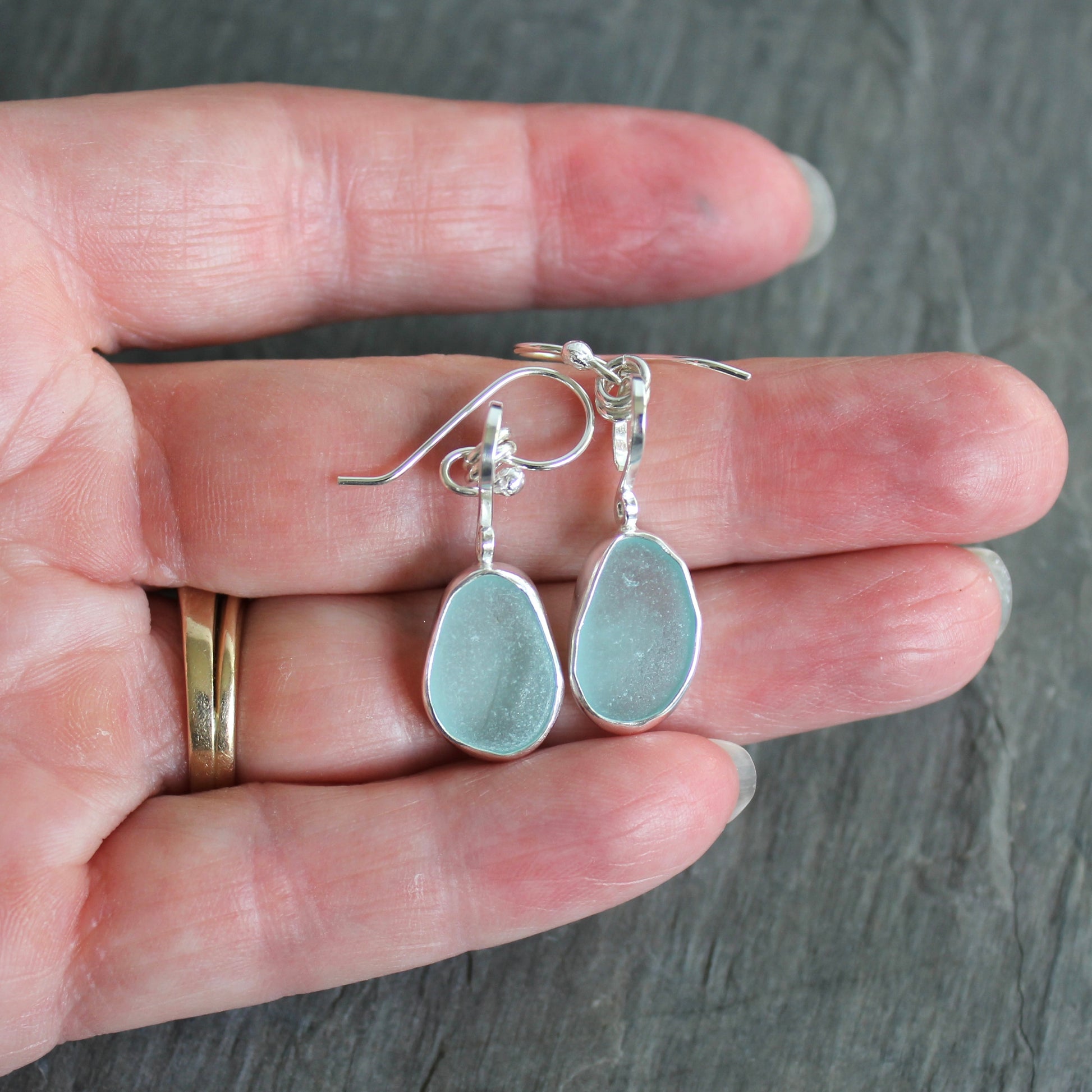 For these pretty earrings, I used 2 pieces of pale blue sea glass from Japan that are set in a sterling & fine silver bezel setting and are on sterling silver ear wires. All of our sea glass is found and never altered in any way. This item was handmade by Barb Macy in Corvallis, OR.

