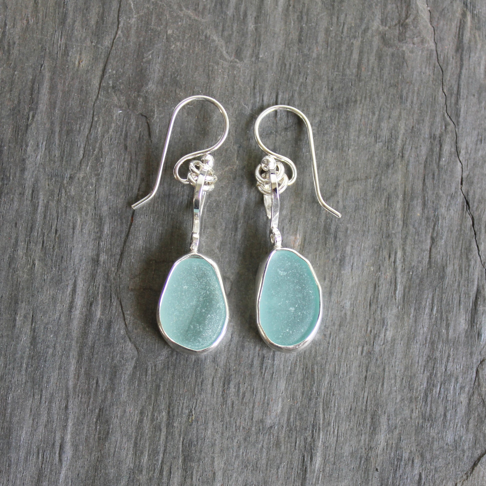 For these pretty earrings, I used 2 pieces of pale blue sea glass from Japan that are set in a sterling & fine silver bezel setting and are on sterling silver ear wires. All of our sea glass is found and never altered in any way. This item was handmade by Barb Macy in Corvallis, OR.
