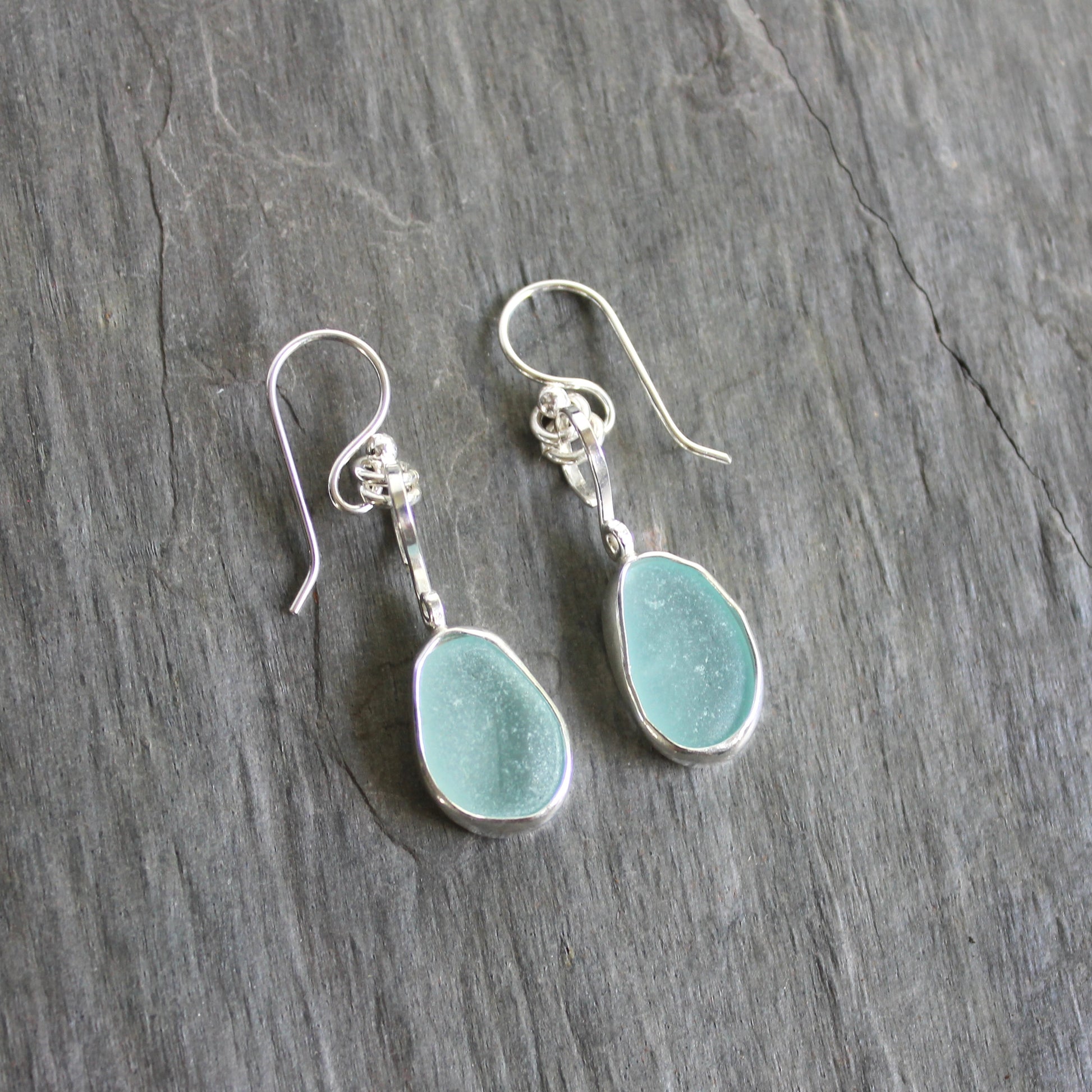 For these pretty earrings, I used 2 pieces of pale blue sea glass from Japan that are set in a sterling & fine silver bezel setting and are on sterling silver ear wires. All of our sea glass is found and never altered in any way. This item was handmade by Barb Macy in Corvallis, OR.
