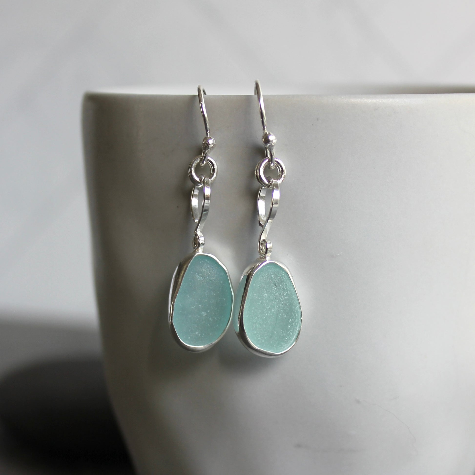For these pretty earrings, I used 2 pieces of pale blue sea glass from Japan that are set in a sterling & fine silver bezel setting and are on sterling silver ear wires. All of our sea glass is found and never altered in any way. This item was handmade by Barb Macy in Corvallis, OR.
