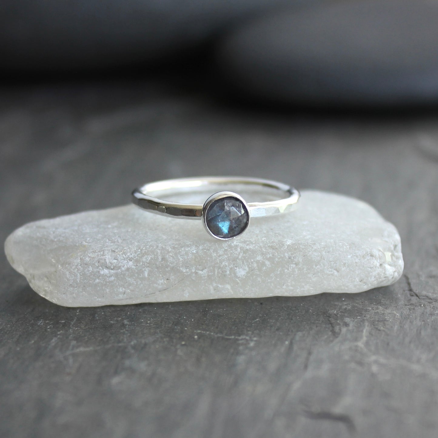 This stackable ring has a 6mm rose cut labradorite cabochon set in a sterling silver bezel on a sturdy hammered band. Available in any size. 