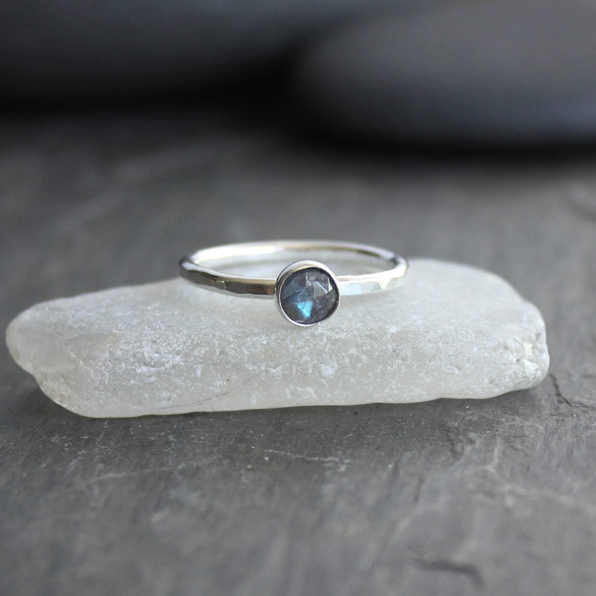 This stackable ring has a 6mm rose cut labradorite cabochon set in a sterling silver bezel on a sturdy hammered band. Available in any size. 