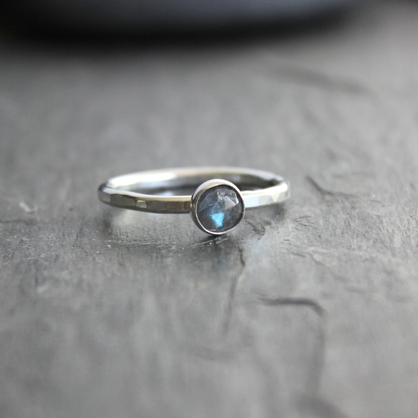 This stackable ring has a 6mm rose cut labradorite cabochon set in a sterling silver bezel on a sturdy hammered band. Available in any size. 