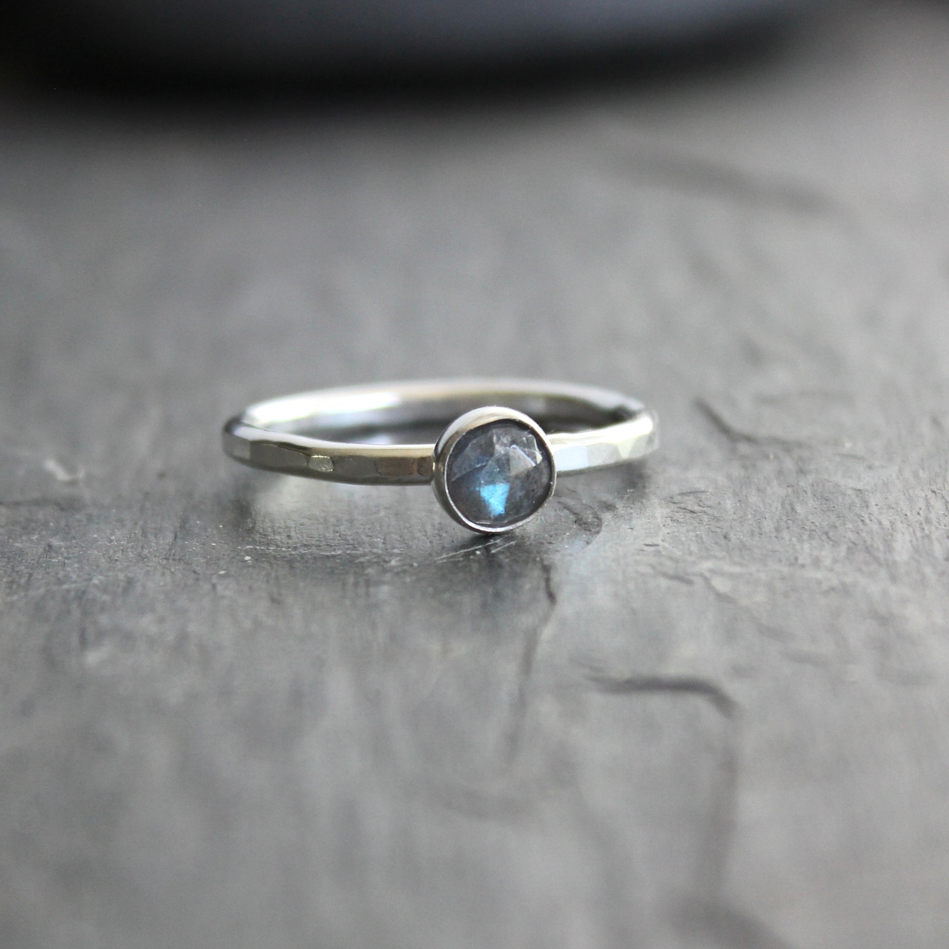 This stackable ring has a 6mm rose cut labradorite cabochon set in a sterling silver bezel on a sturdy hammered band. Available in any size. 