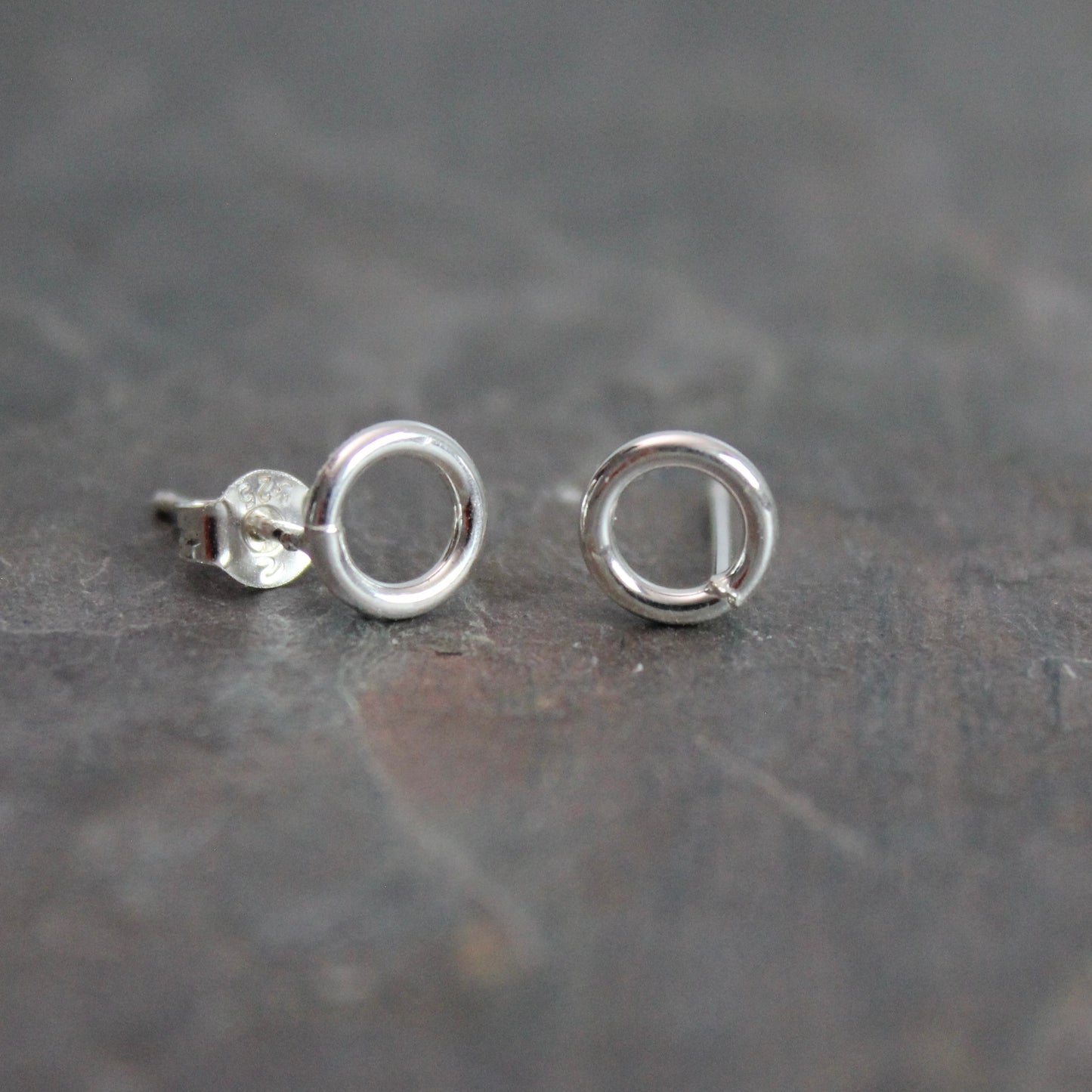 These cute little stud earrings have simple 8-10mm jump rings solders onto sterling silver posts and completed with ear nuts. Handmade by Barb Macy in Corvallis, Oregon.