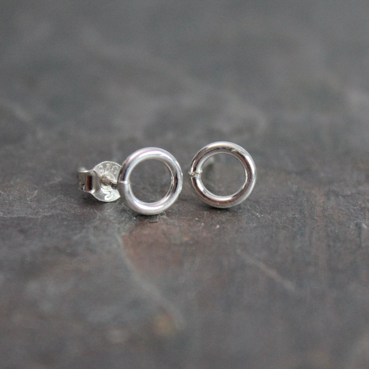 These cute little stud earrings have simple 8-10mm jump rings solders onto sterling silver posts and completed with ear nuts. Handmade by Barb Macy in Corvallis, Oregon.