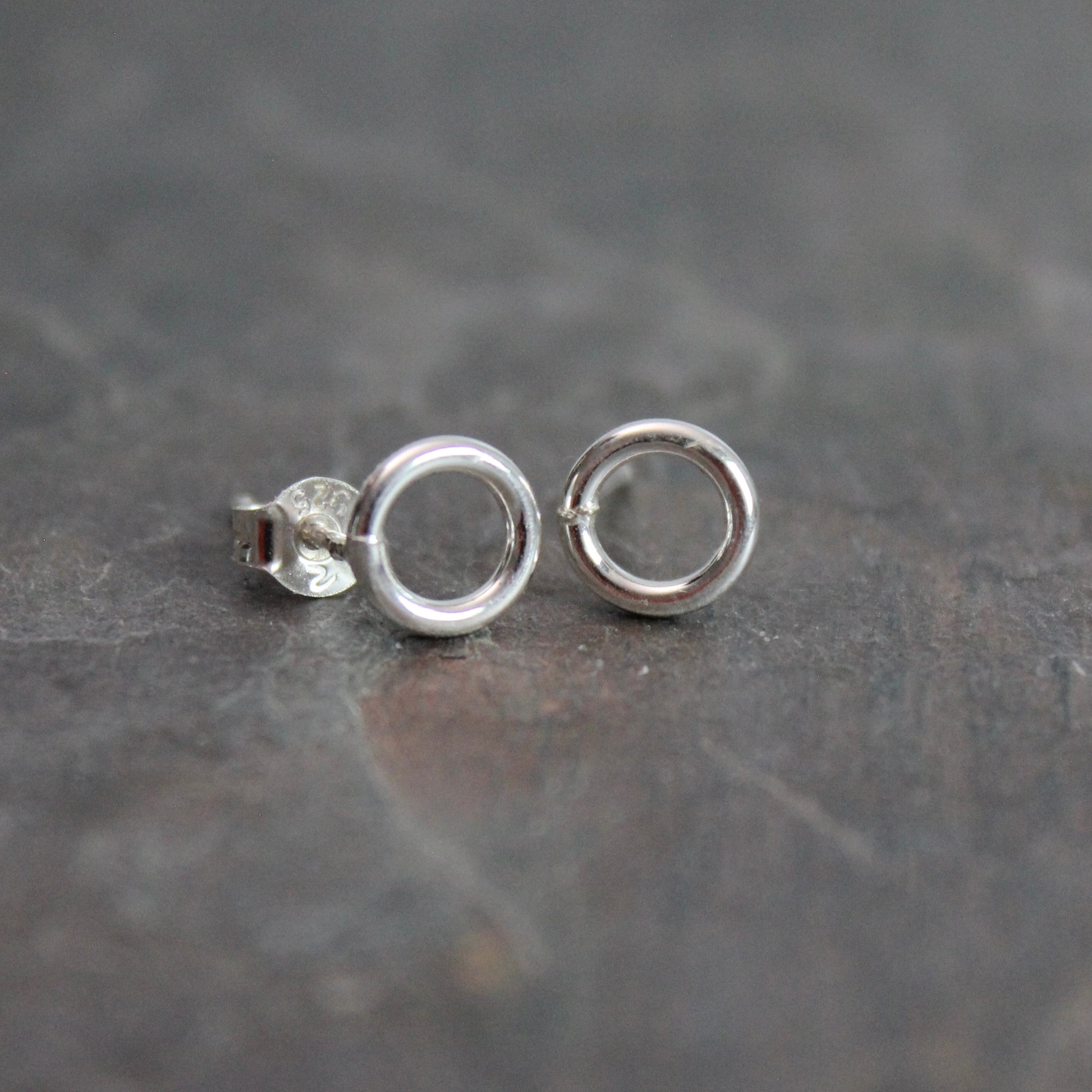 These cute little stud earrings have simple 8-10mm jump rings solders onto sterling silver posts and completed with ear nuts. Handmade by Barb Macy in Corvallis, Oregon.