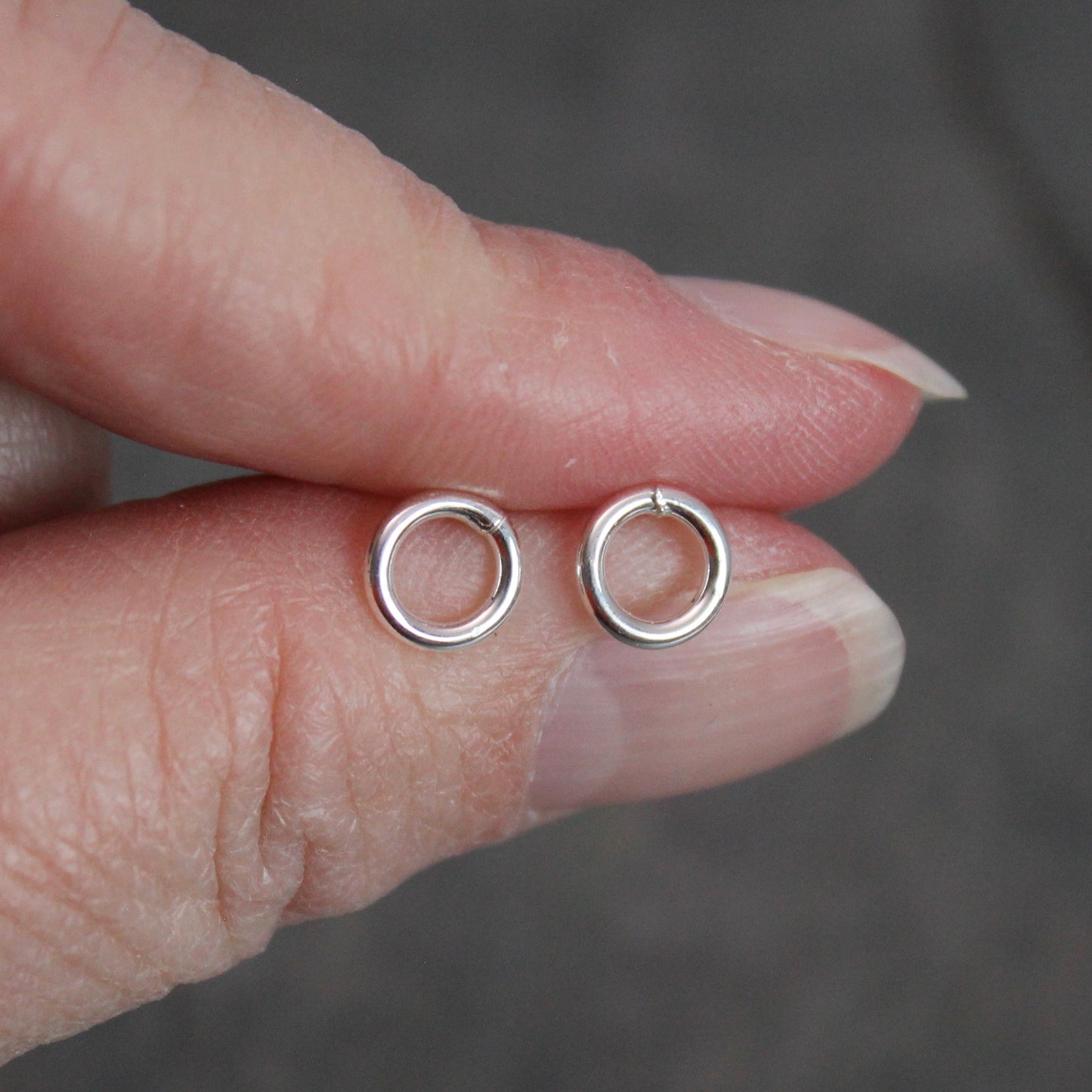 These cute little stud earrings have simple 8-10mm jump rings solders onto sterling silver posts and completed with ear nuts. Handmade by Barb Macy in Corvallis, Oregon.
