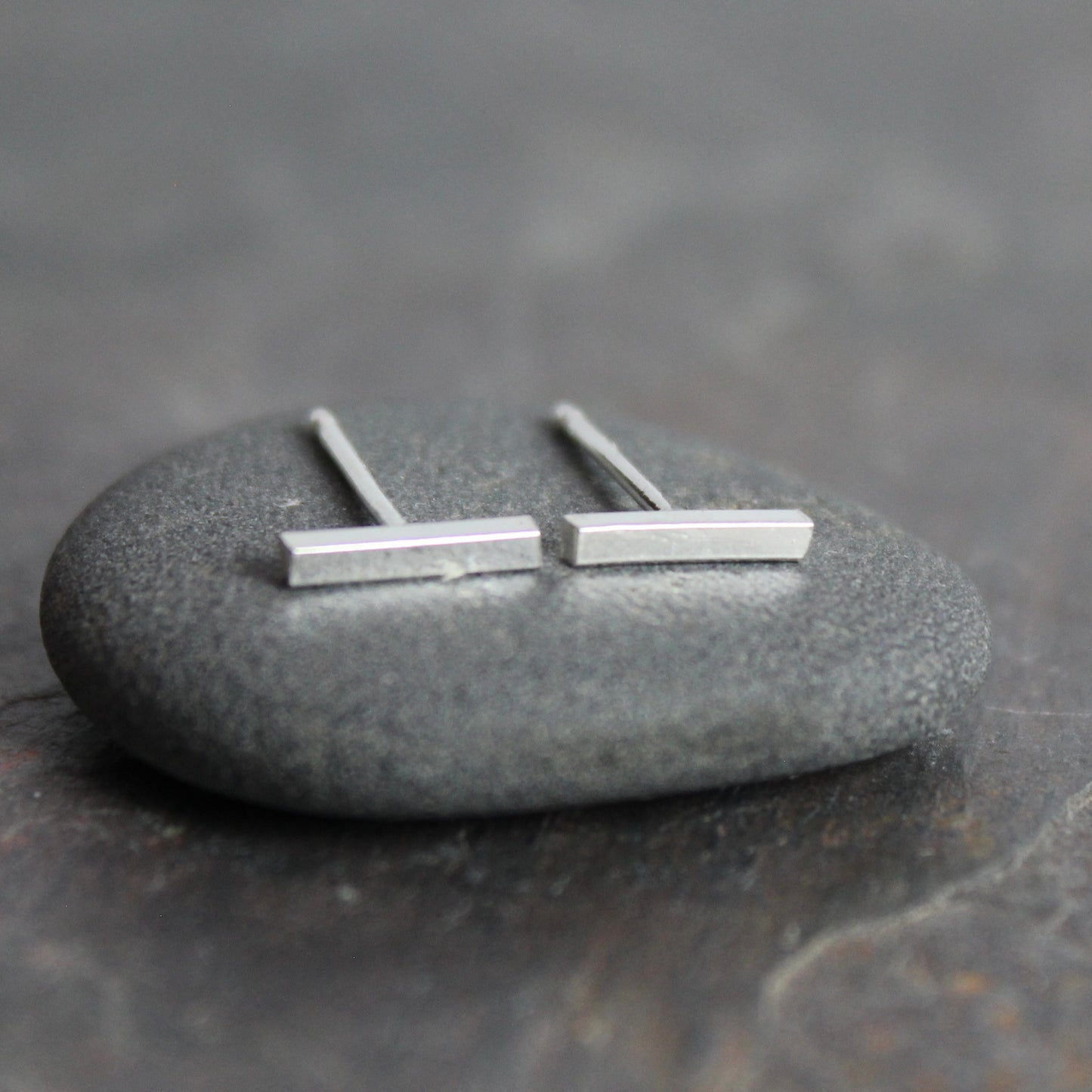 sterling silver bar studs that are approximately 8mm in length. 