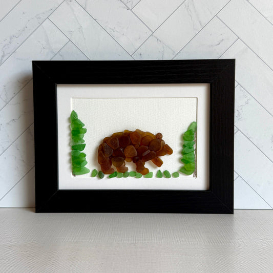 Framed artwork of a bear and trees on a white background