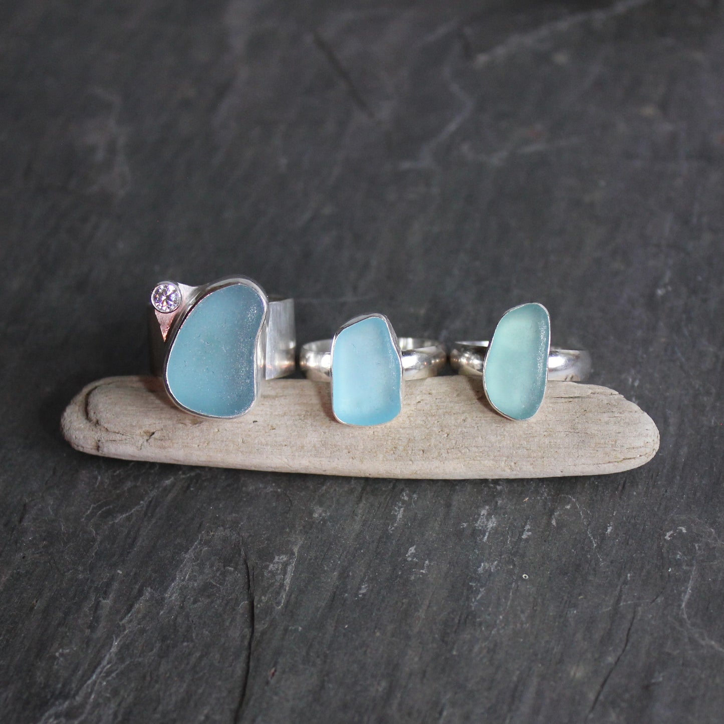 A set of 3 Aqua blue sea glass rings set in fine & sterling silver. Accent Yourself specializes in sterling silver jewelry handmade by Barb Macy & Will Macy in Corvallis, OR.