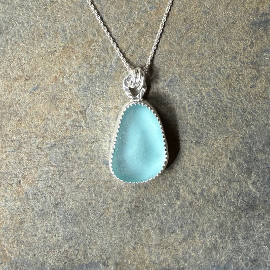 Aqua Sea Glass Necklace on a stone surface