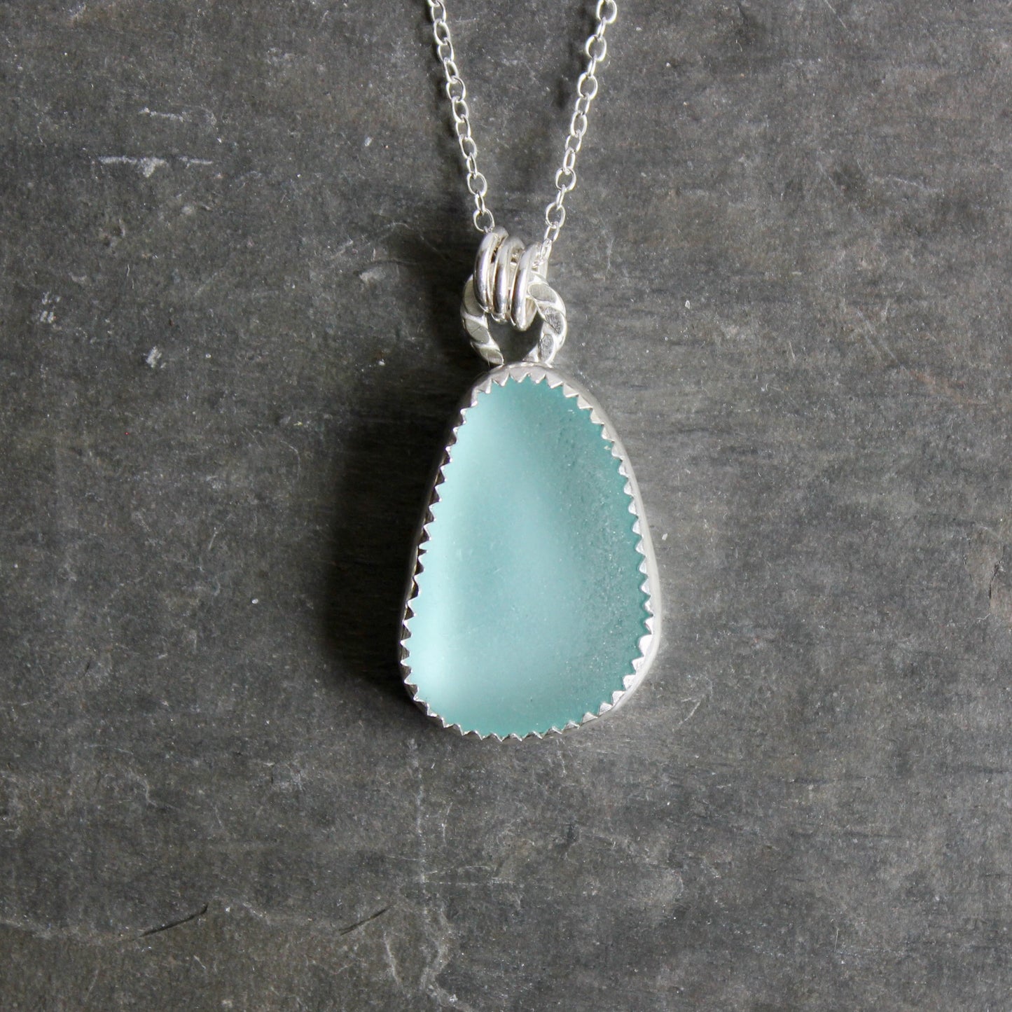 Teal Sea Glass necklace on a dark gray background