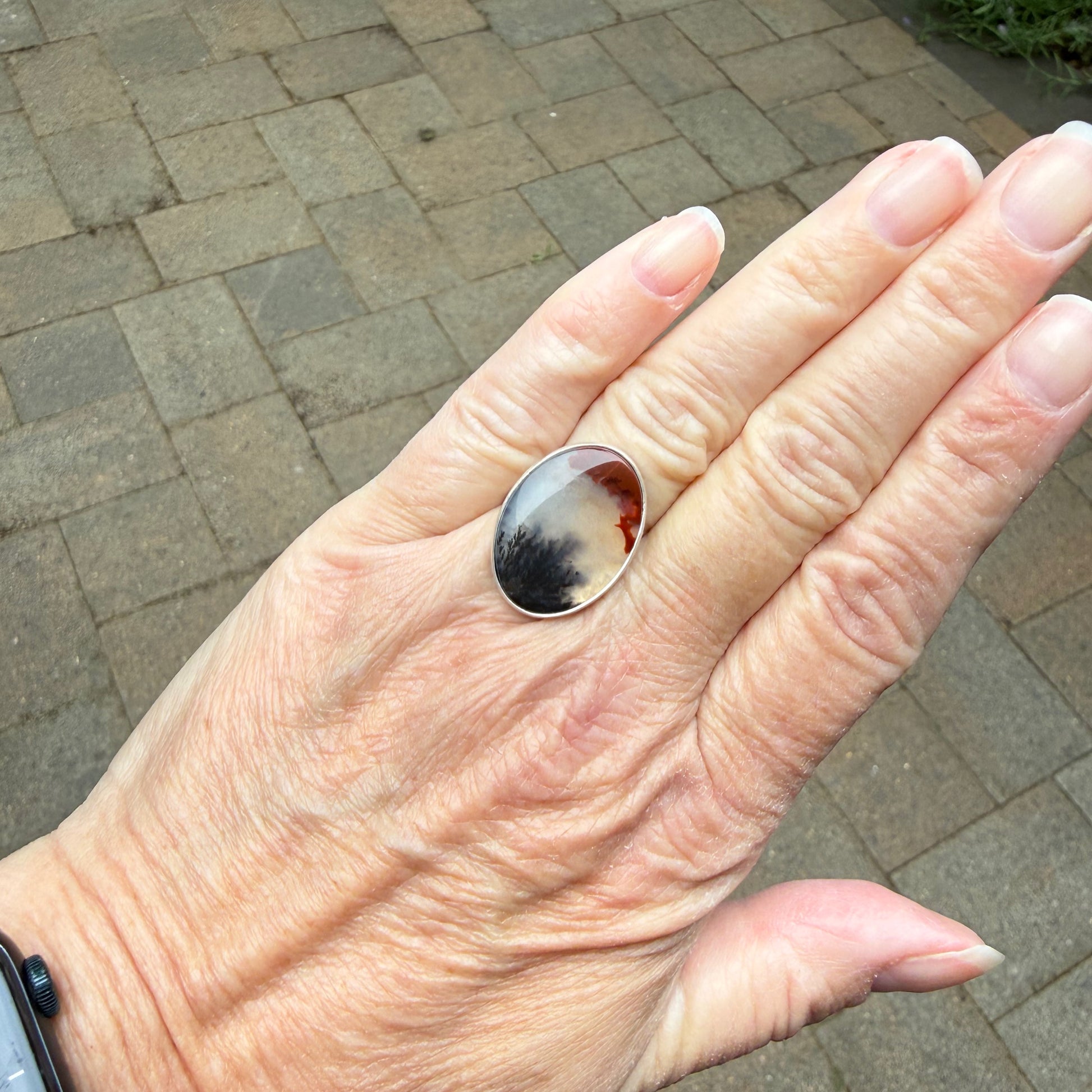 Crooked River Oregon Agate ring worn on hand, showing natural stone patterns and hammered sterling silver band