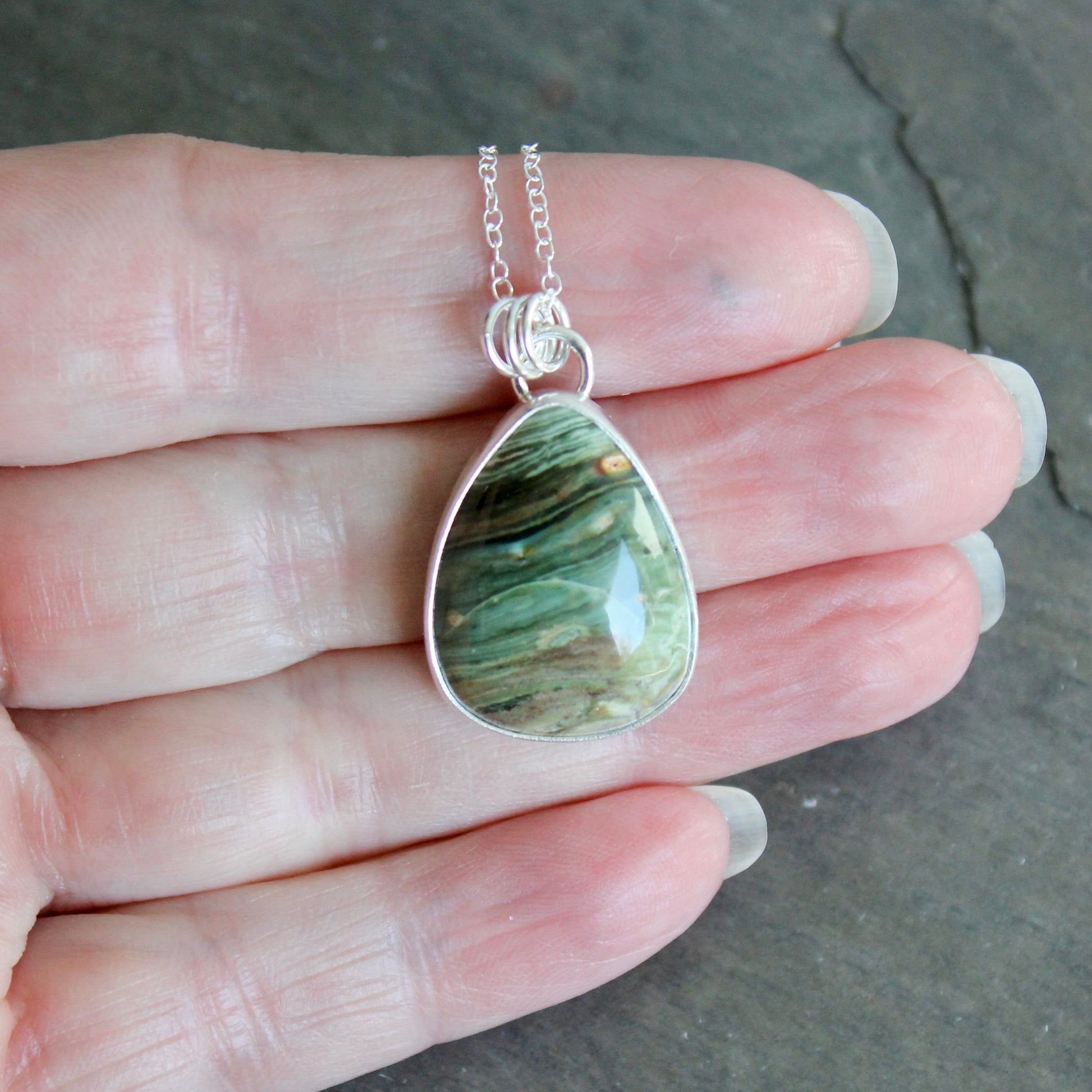 Teardrop-shaped pendant with a bezel set gary green jasper 