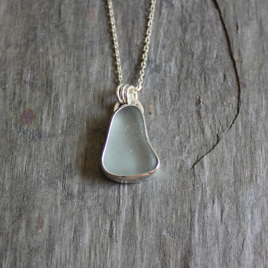 This pendant has a chunky piece of gray sea glass and it is set in a fine and sterling silver bezel setting with an 18" chain.  