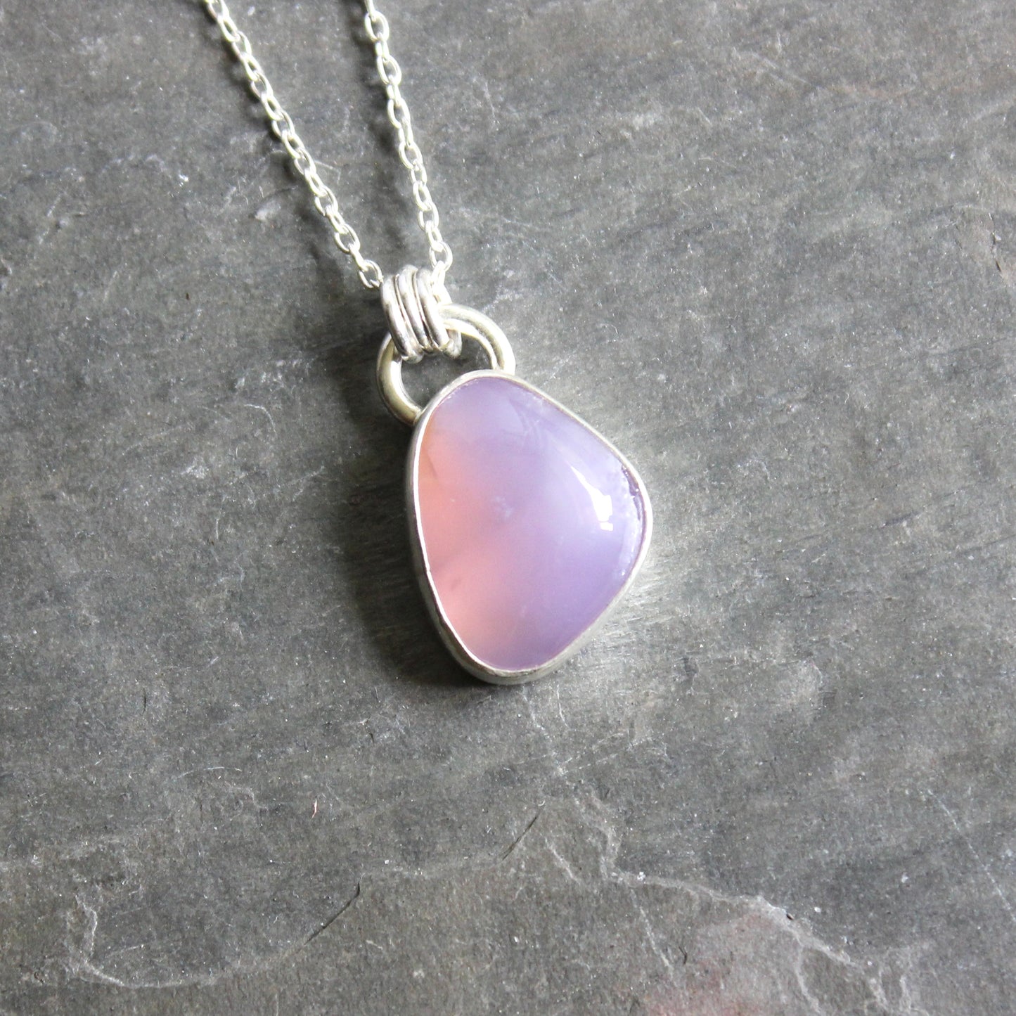 Necklace with a Holley Blue Agate teardrop pendant on a gray 