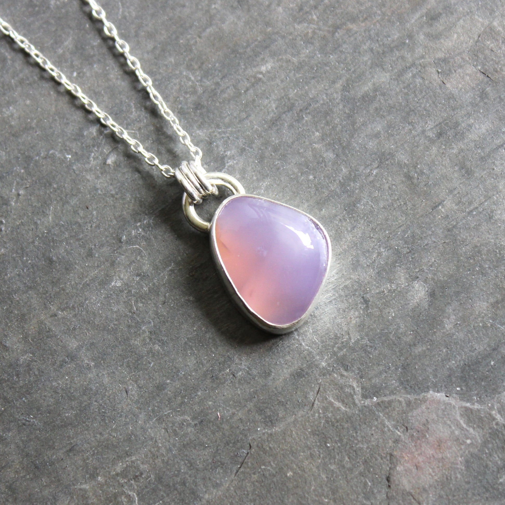 Necklace with a Holley Blue Agate teardrop pendant on a gray 