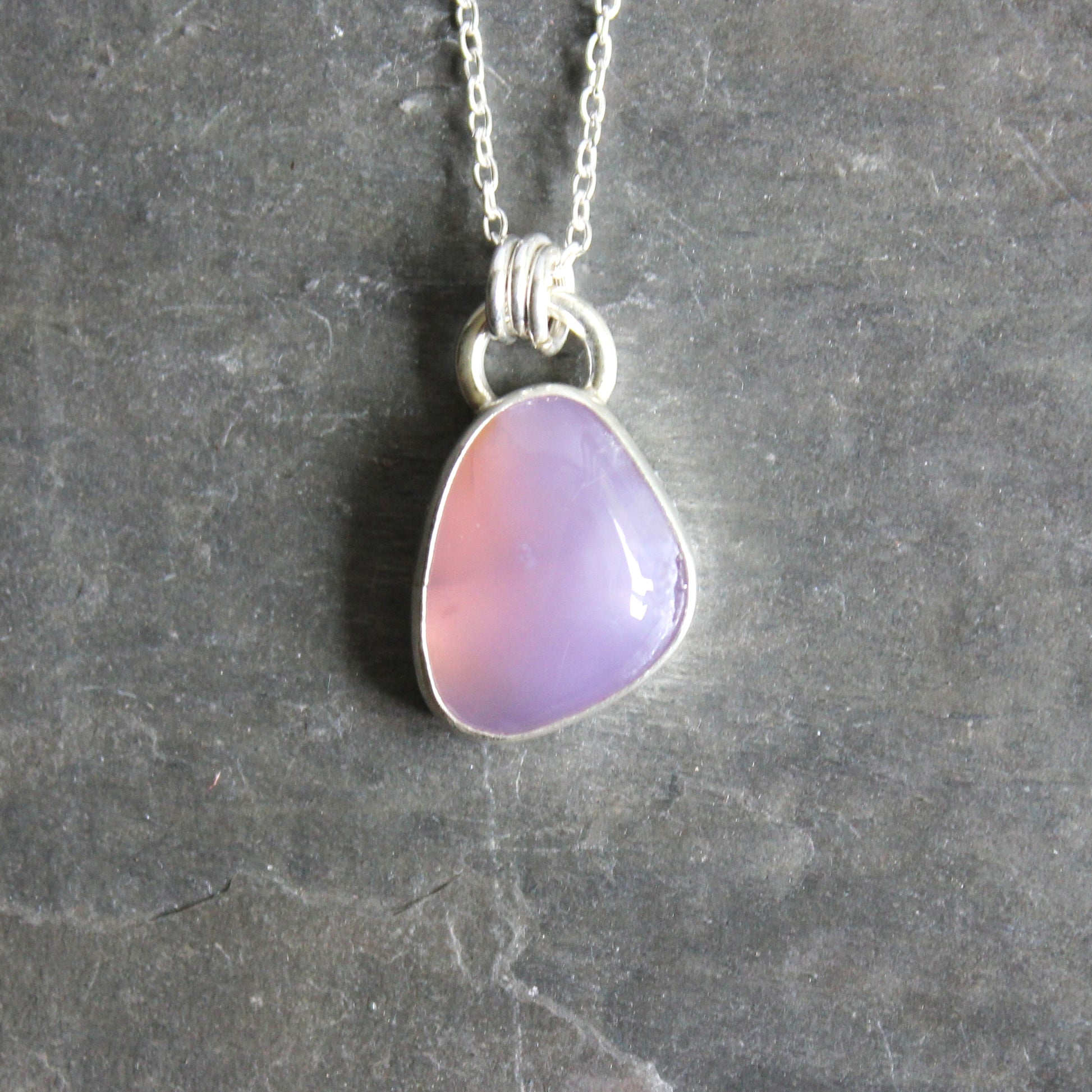 Necklace with a Holley Blue Agate teardrop pendant on a gray background