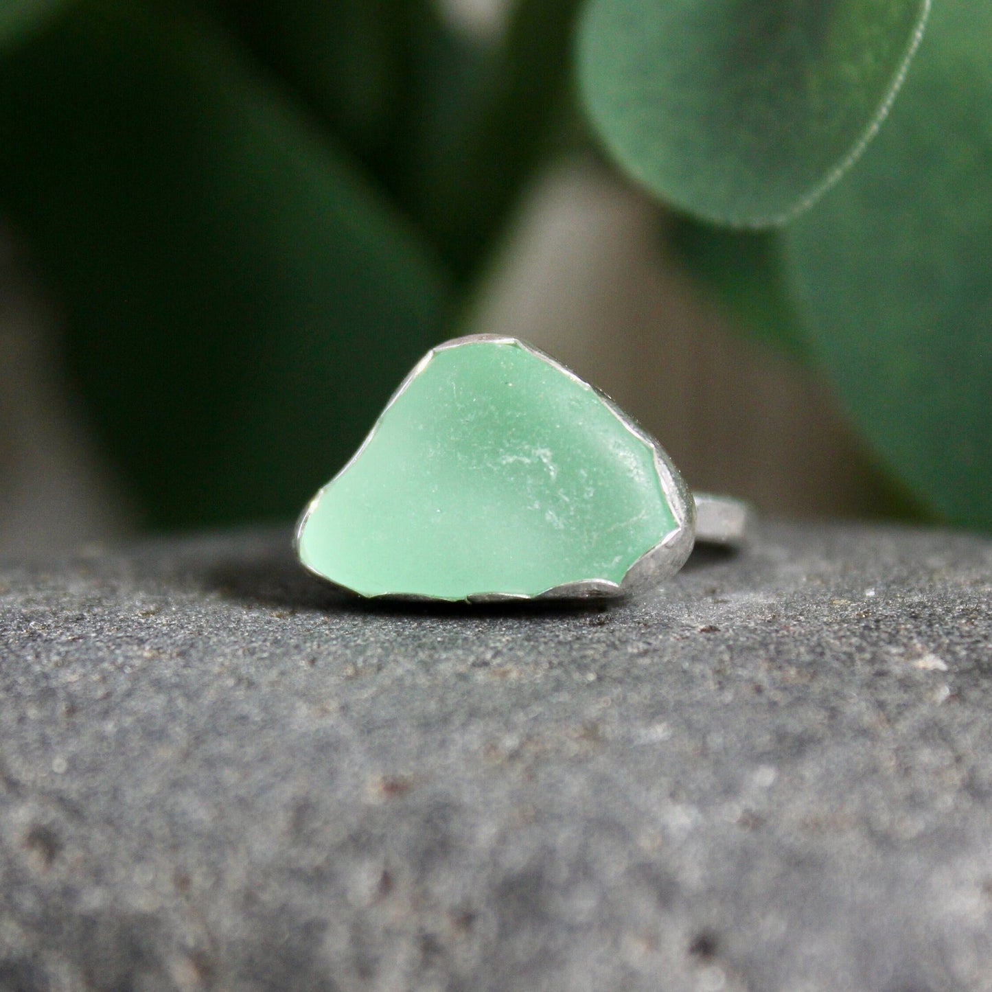 This ring has a sea foam green piece of sea glass set in a fine and sterling silver scalloped bezel setting on a sturdy silver band.  Handmade by Barb Macy in Corvallis, OR.  Size 4 1/4