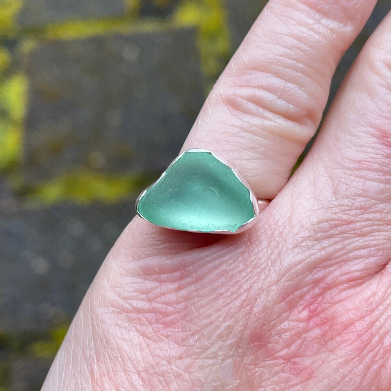 This ring has a sea foam green piece of sea glass set in a fine and sterling silver scalloped bezel setting on a sturdy silver band.  Handmade by Barb Macy in Corvallis, OR.  Size 4 1/4