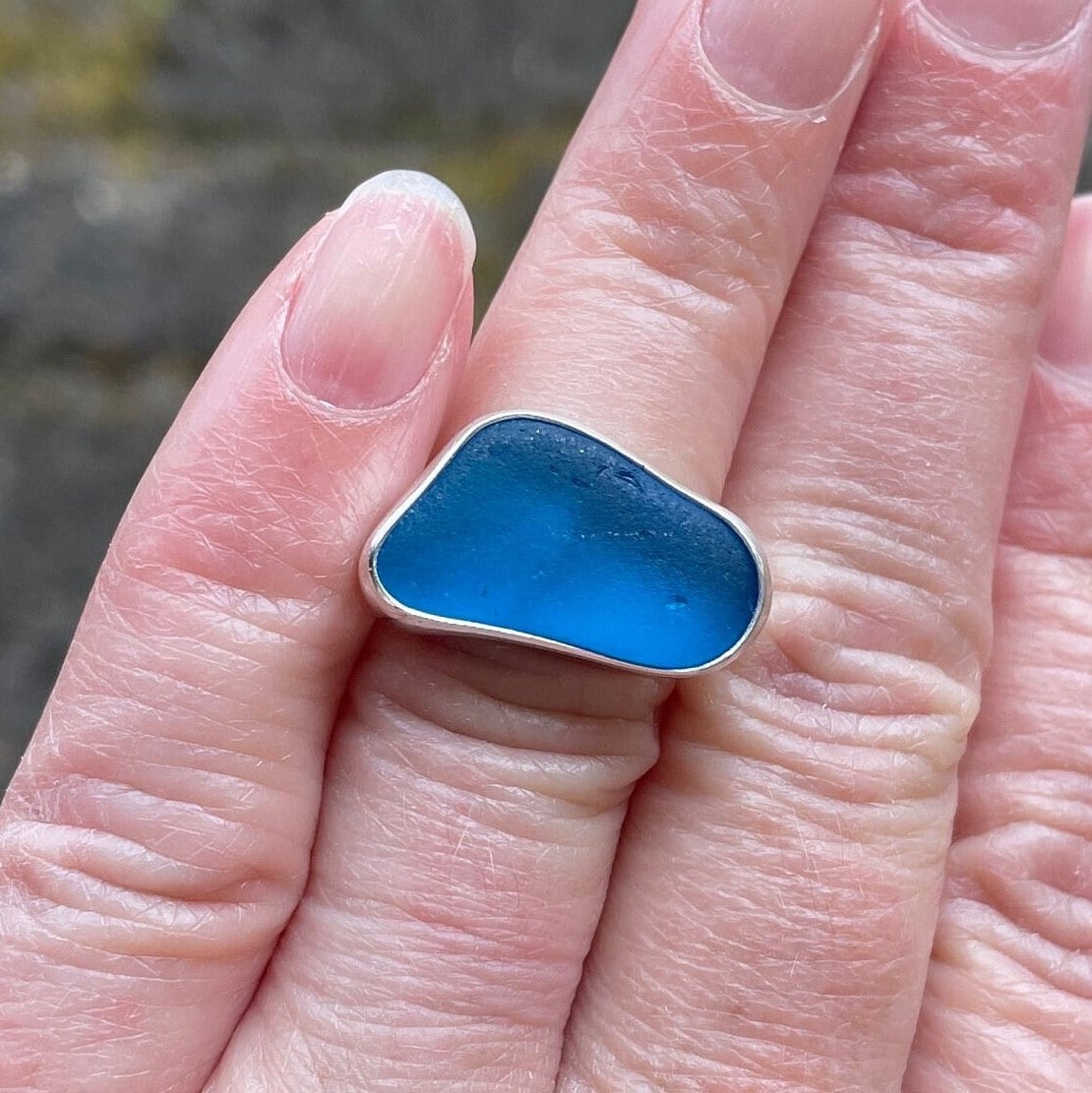 This ring has an ultra rare piece of vivid dark turquoise blue sea glass from Martinique in the Caribbean.  It is set in a plain fine & sterling silver bezel on a sturdy silver band.  Size 4 3/4