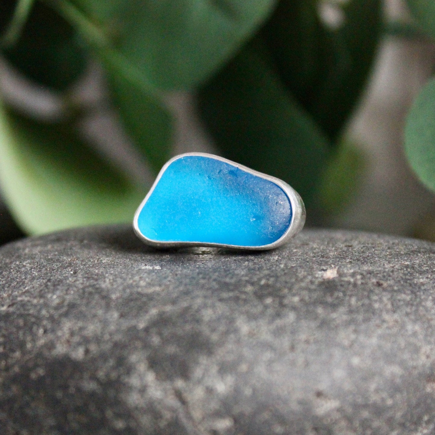 This ring has an ultra rare piece of vivid dark turquoise blue sea glass from Martinique in the Caribbean.  It is set in a plain fine & sterling silver bezel on a sturdy silver band.  Size 4 3/4