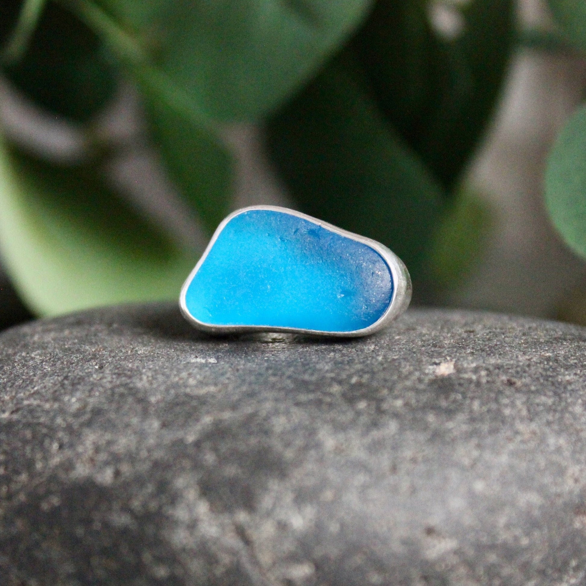 This ring has an ultra rare piece of vivid dark turquoise blue sea glass from Martinique in the Caribbean.  It is set in a plain fine & sterling silver bezel on a sturdy silver band.  Size 4 3/4