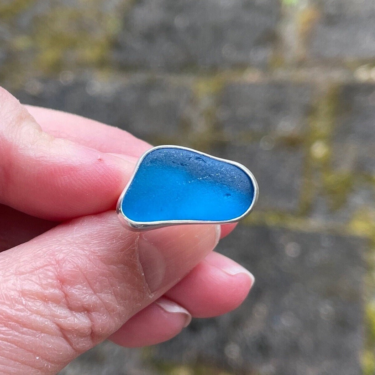 This ring has an ultra rare piece of vivid dark turquoise blue sea glass from Martinique in the Caribbean.  It is set in a plain fine & sterling silver bezel on a sturdy silver band.  Size 4 3/4