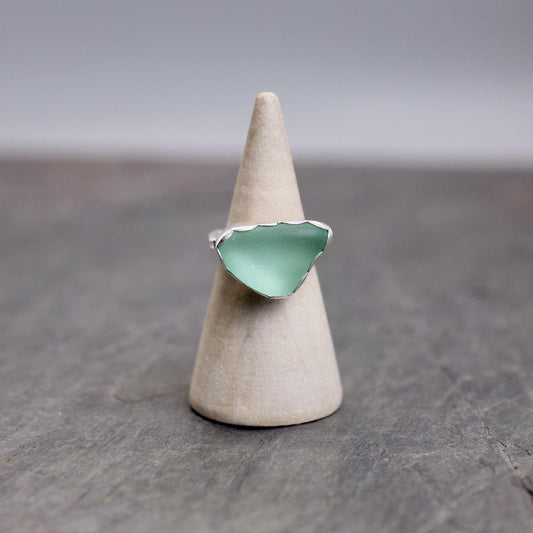 This ring has a sea foam green piece of sea glass set in a fine and sterling silver scalloped bezel setting on a sturdy silver band.  Handmade by Barb Macy in Corvallis, OR.  Size 4 1/4