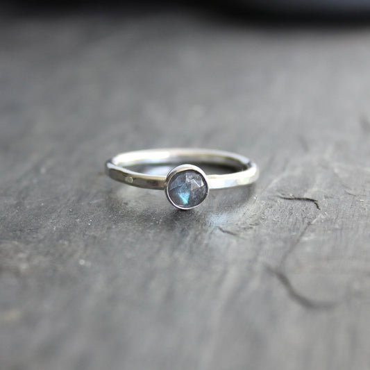 This stackable ring has a 6mm rose cut labradorite cabochon set in a sterling silver bezel on a sturdy hammered band. Available in any size. 