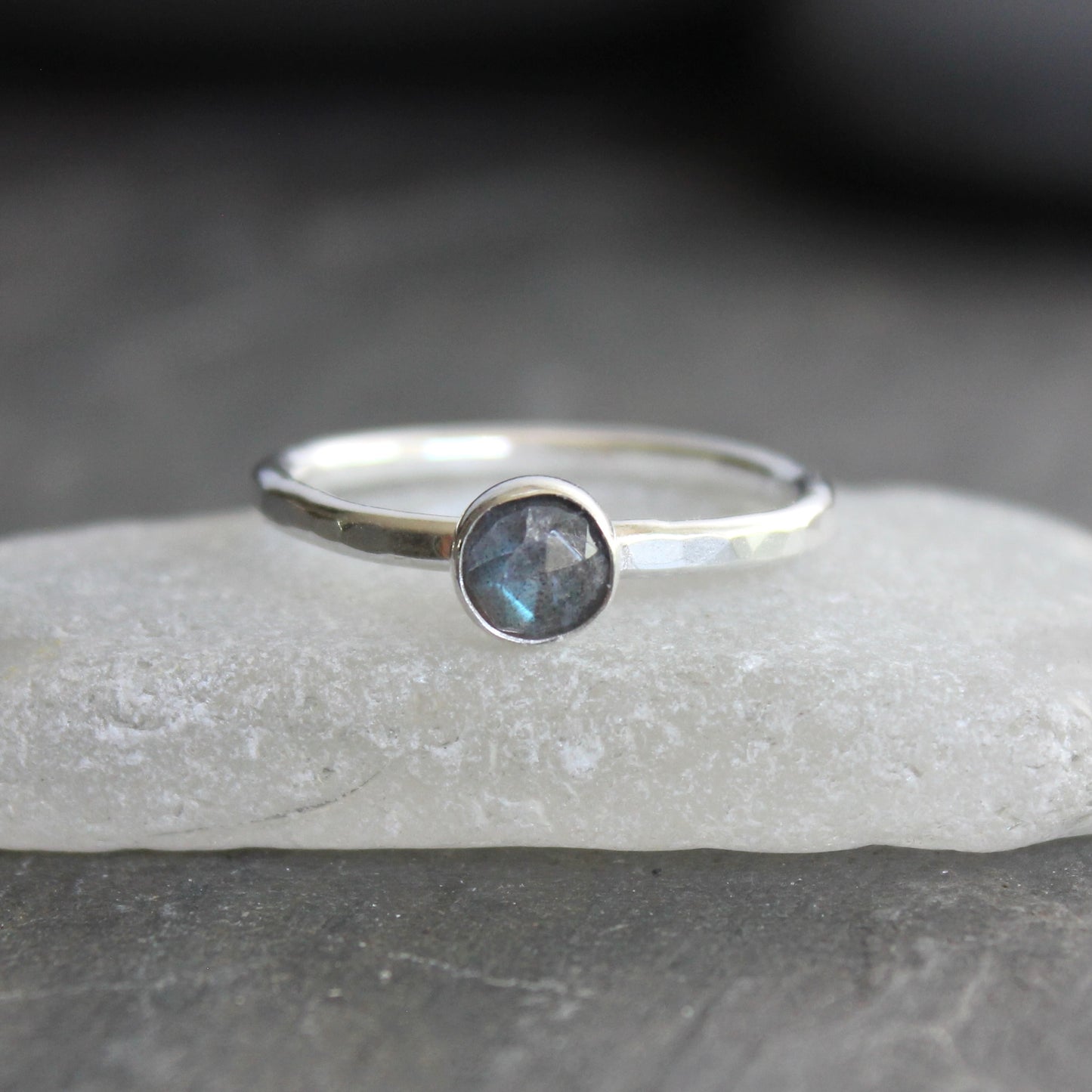 This stackable ring has a 6mm rose cut labradorite cabochon set in a sterling silver bezel on a sturdy hammered band. Available in any size. 