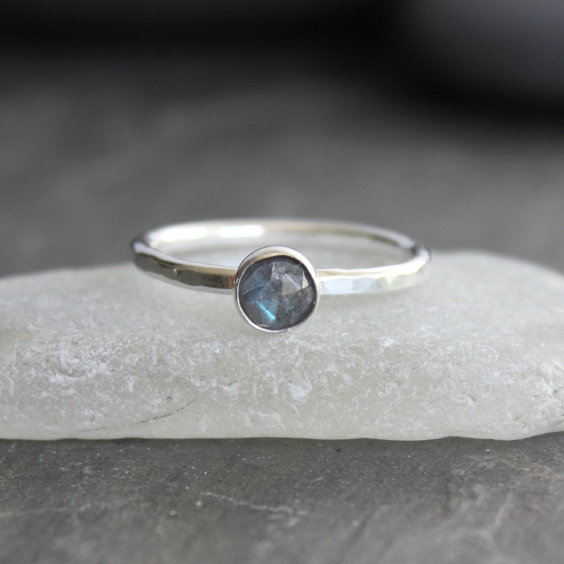 This stackable ring has a 6mm rose cut labradorite cabochon set in a sterling silver bezel on a sturdy hammered band. Available in any size. 
